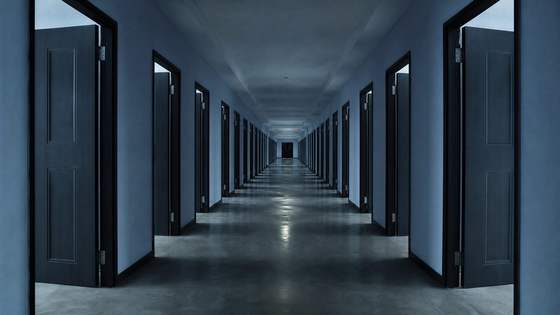 A long corridor lined with open doors