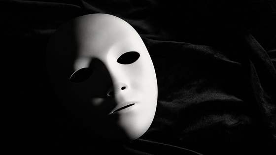 A white mask on a dark background