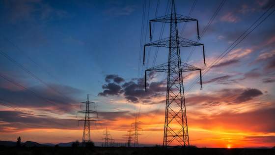 Power lines against a sunset sky